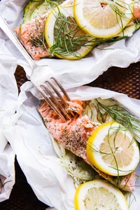 Salmon en papillote with vegetables opened on a plate